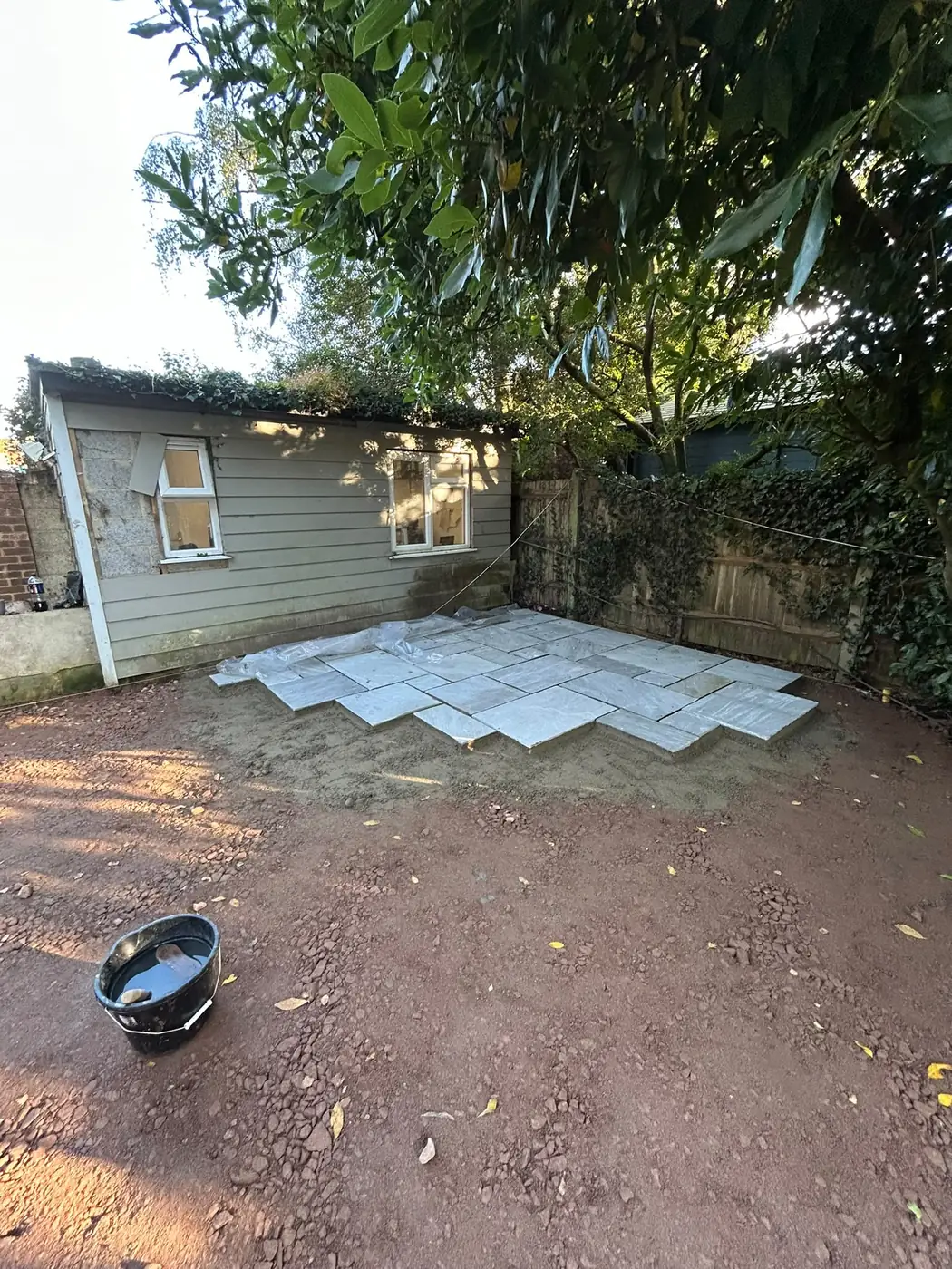 First silver-grey sandstone slabs laid beside the studio