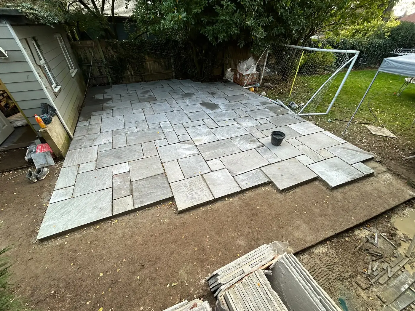 Project-pack sandstone paving extending across the garden