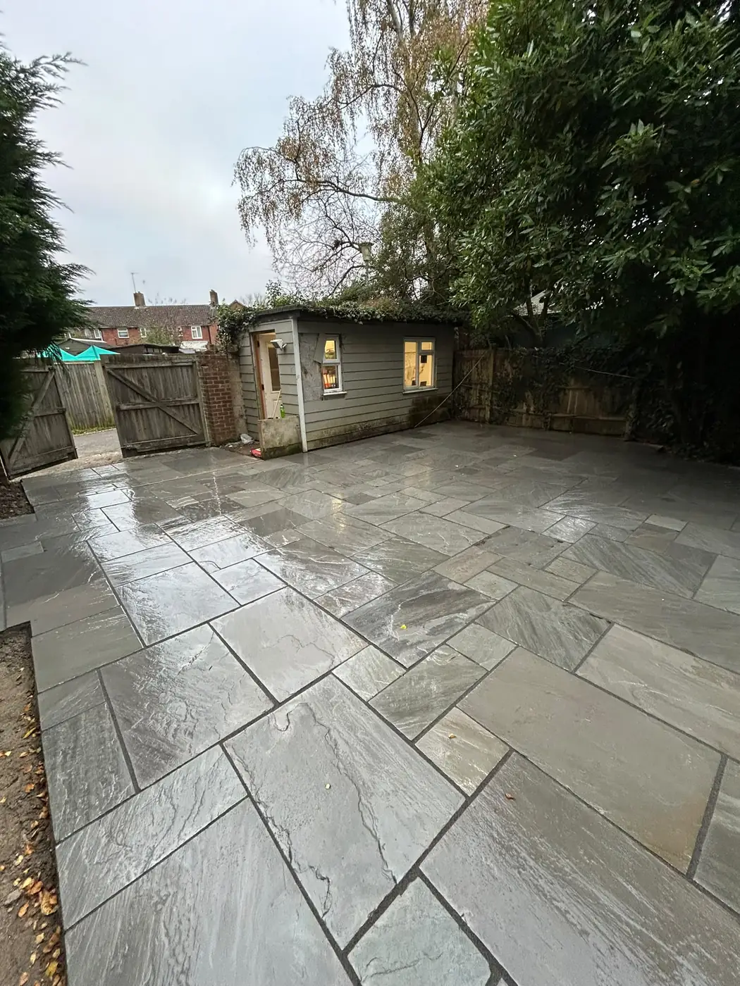 Wide view of the finished silver-grey sandstone patio