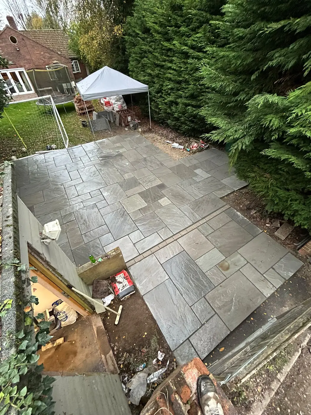 Completed sandstone patio within the wider garden