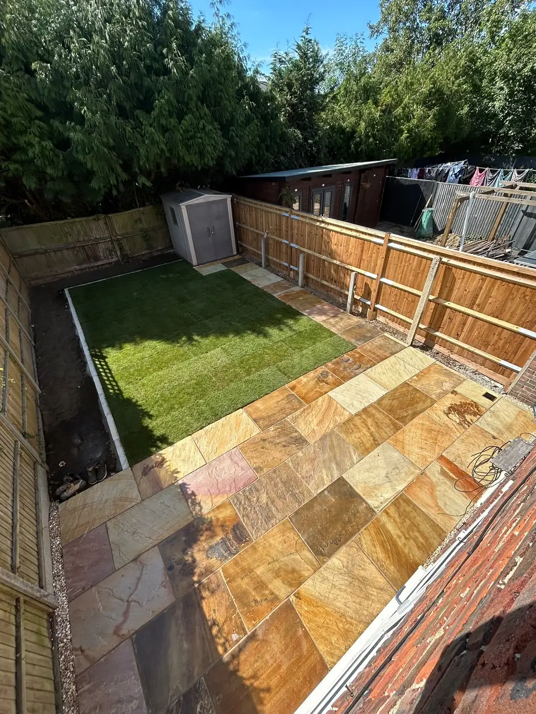 Finished lawn, planting borders and sandstone patio viewed from above