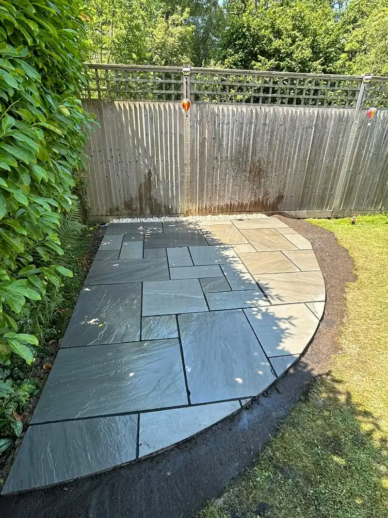 Completed circular grey sandstone garden patio