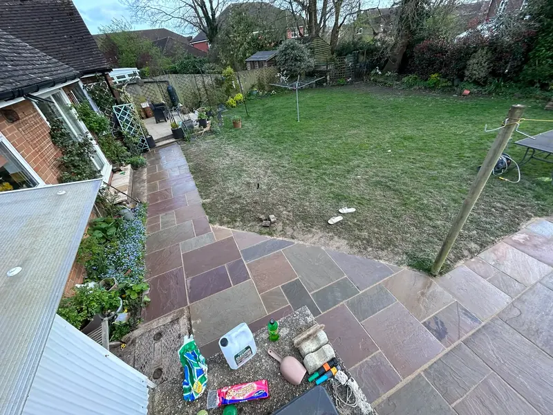 Sandstone patio and garden lawn overview